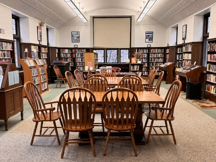 Reading room at the Waban Library in Waban Massachusetts  chairs around tables surrounded by bookshelves